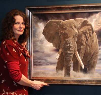 Emma Bowring stood next to a painting of an elephant